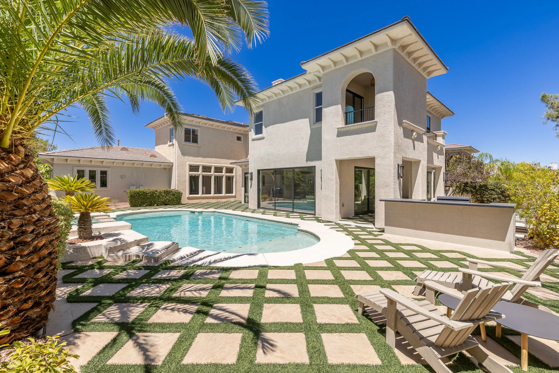Backyard pool and lawn behind the two-storey home